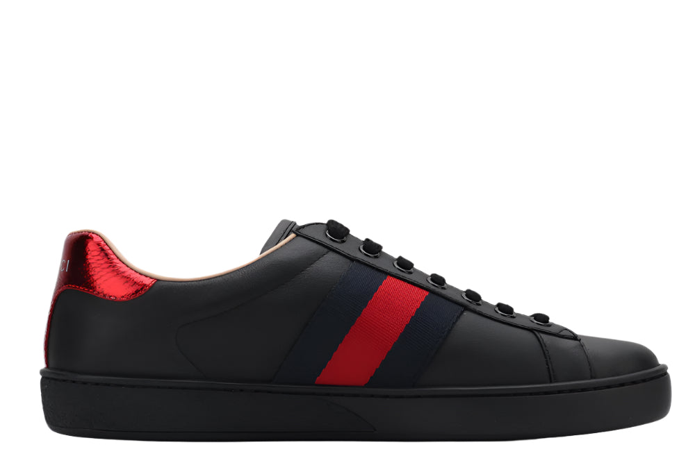 Black sneaker with a red stripe on a light gray background