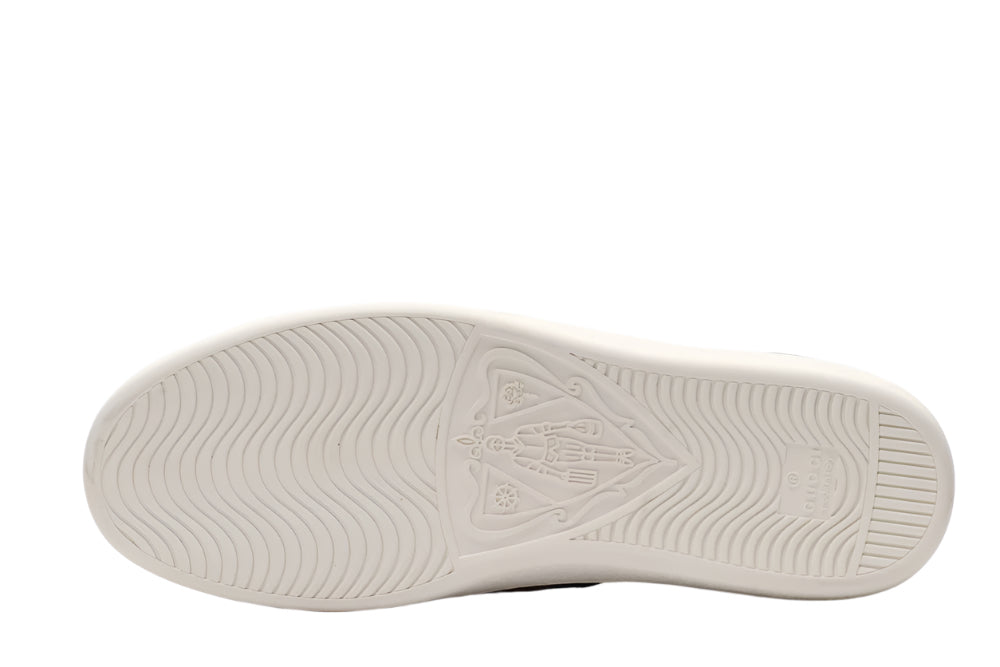 White sneaker sole with brand logo on a light gray background