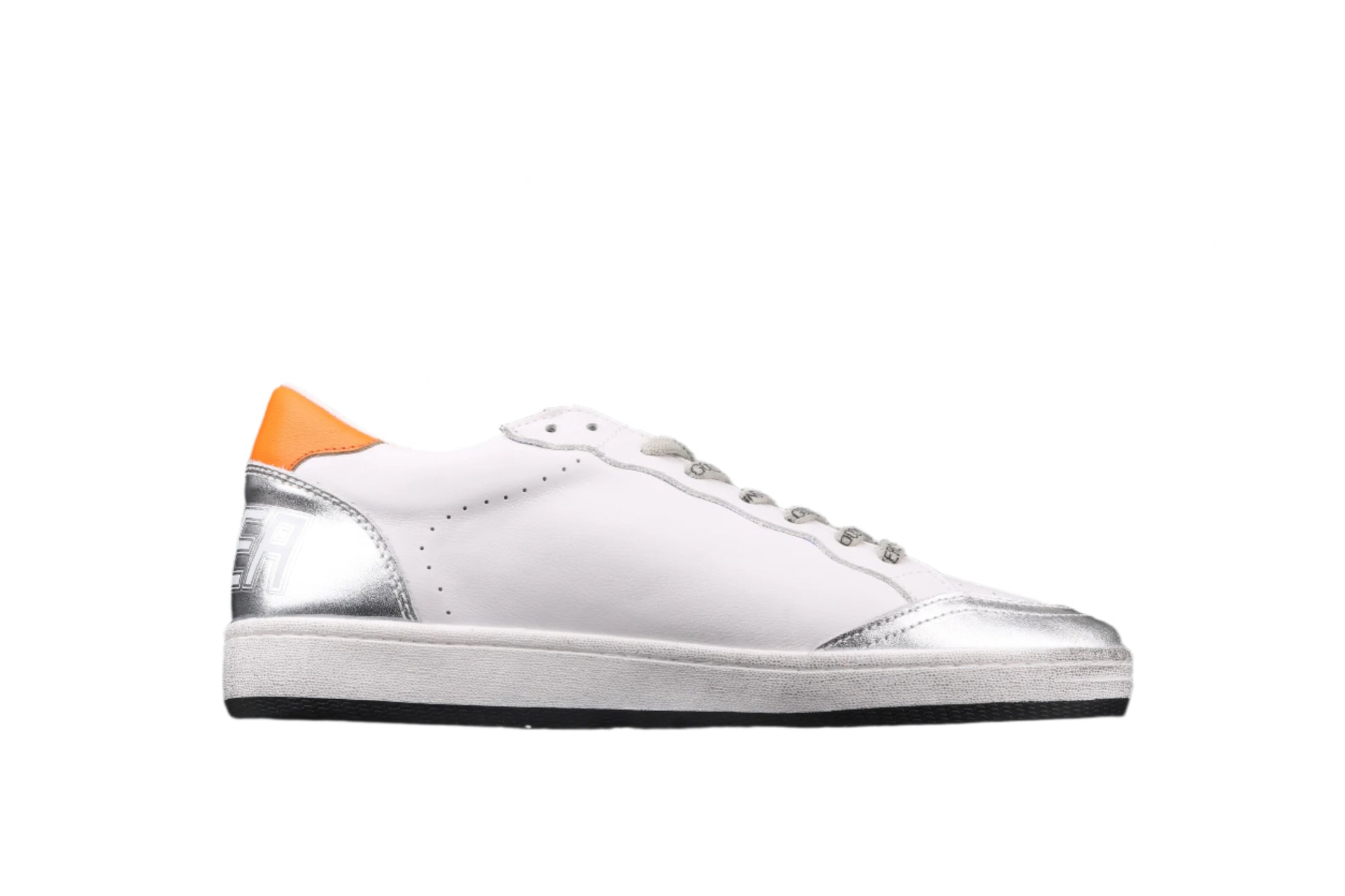 White sneaker with orange and silver accents on a black background
