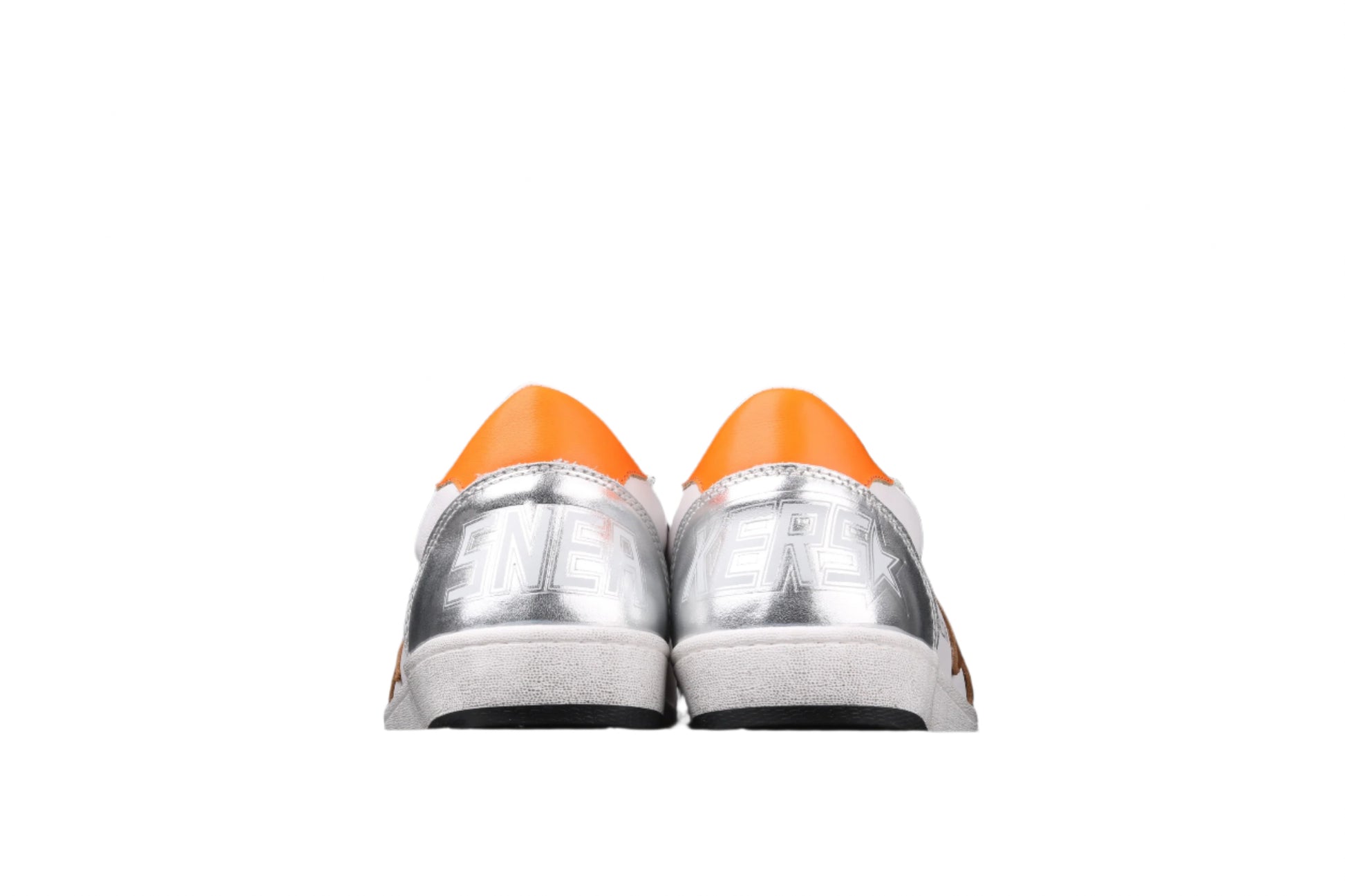 Pair of silver sneakers with orange tips on a black background