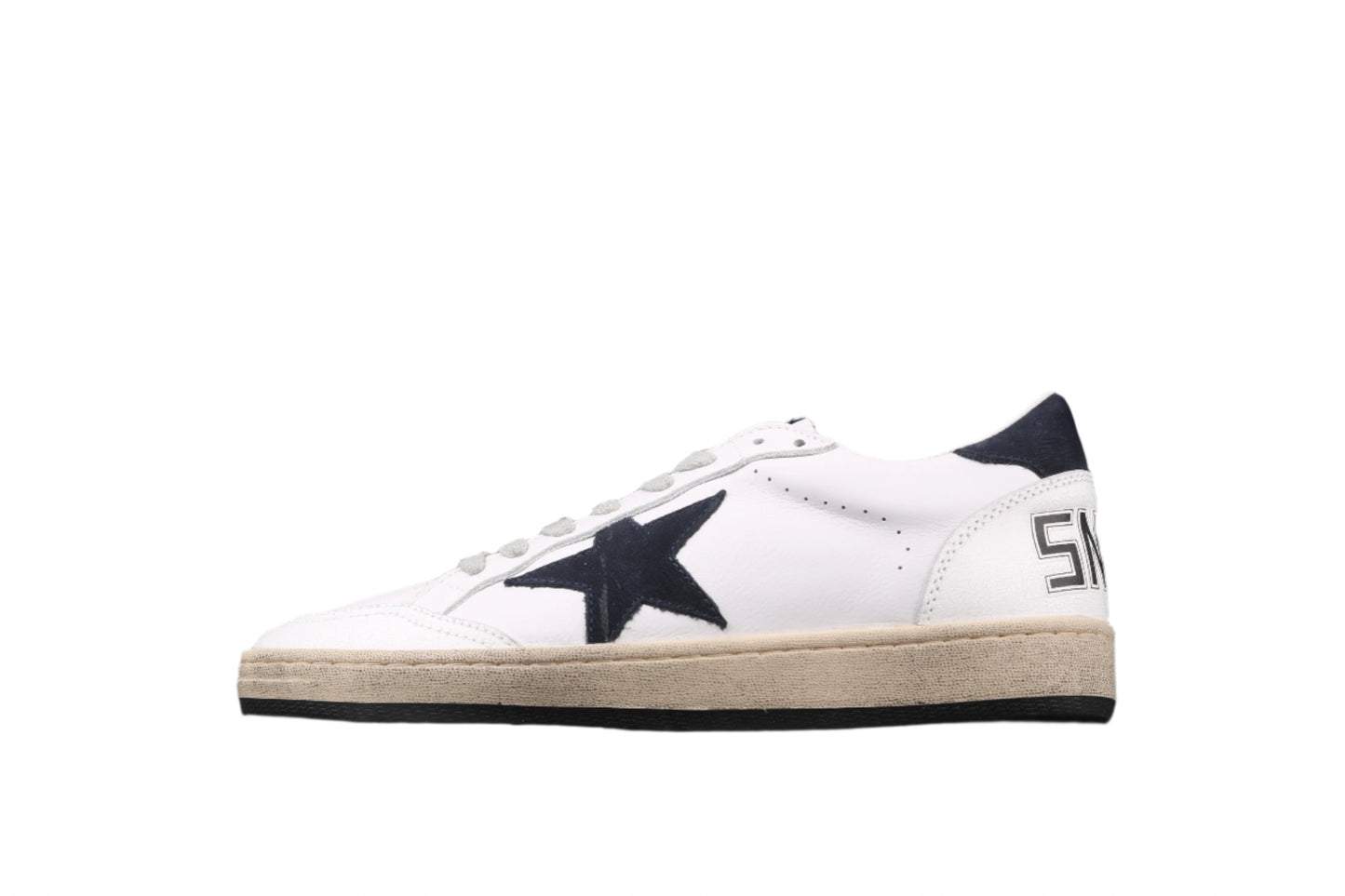 White sneaker with a black star on a black background