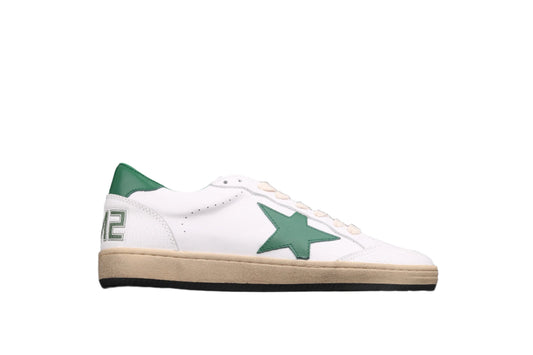 White sneaker with green accents on a black background