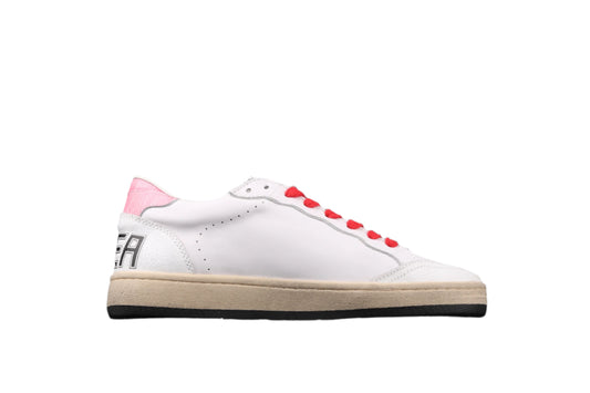 White sneaker with red accents on a black background