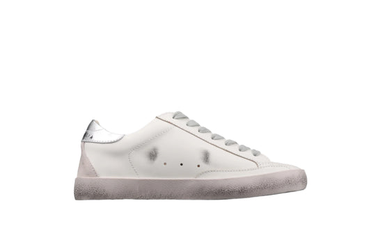 White sneaker with gray sole on a black background