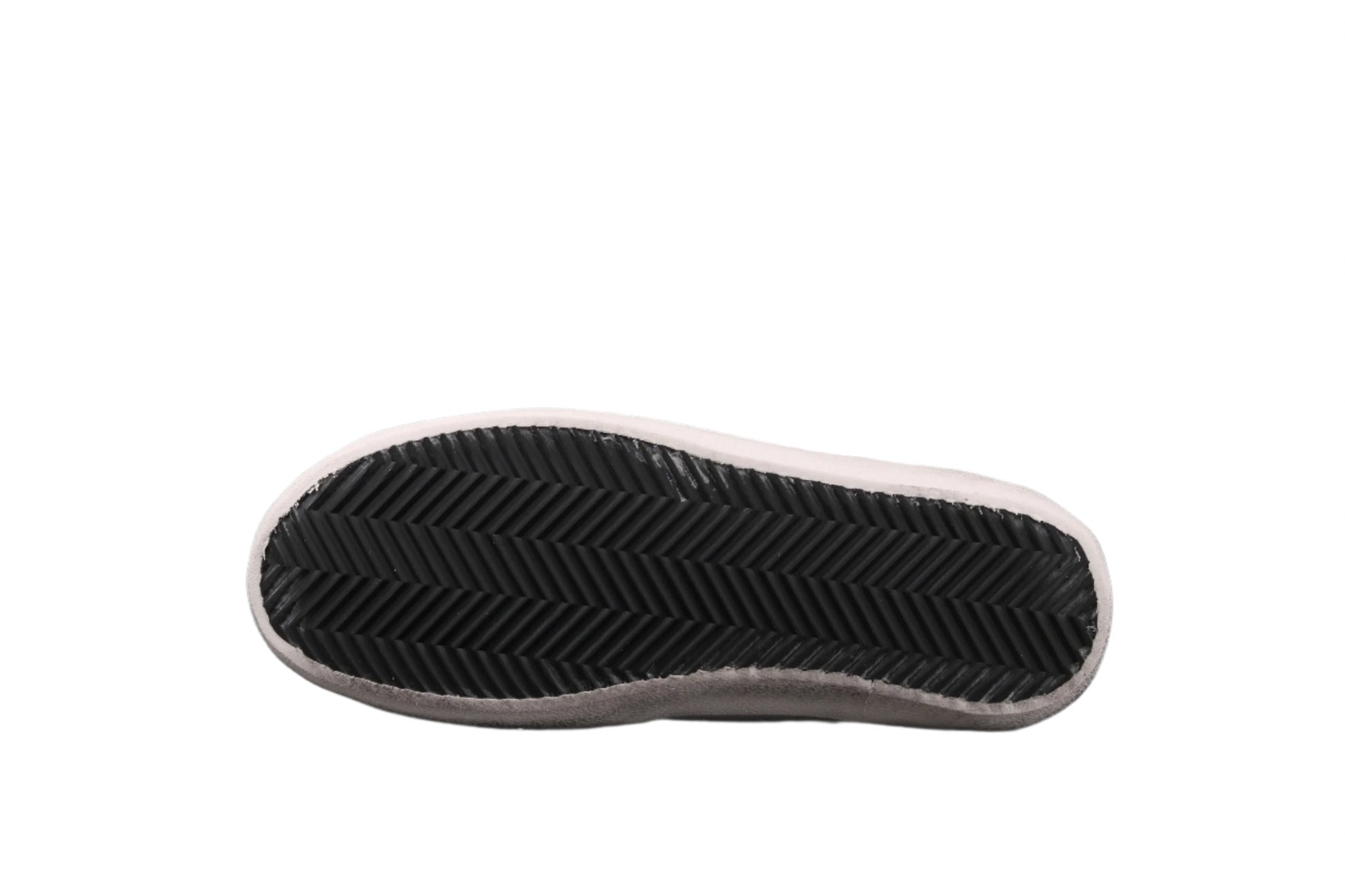 Black sole of a shoe on a white platform with a black background