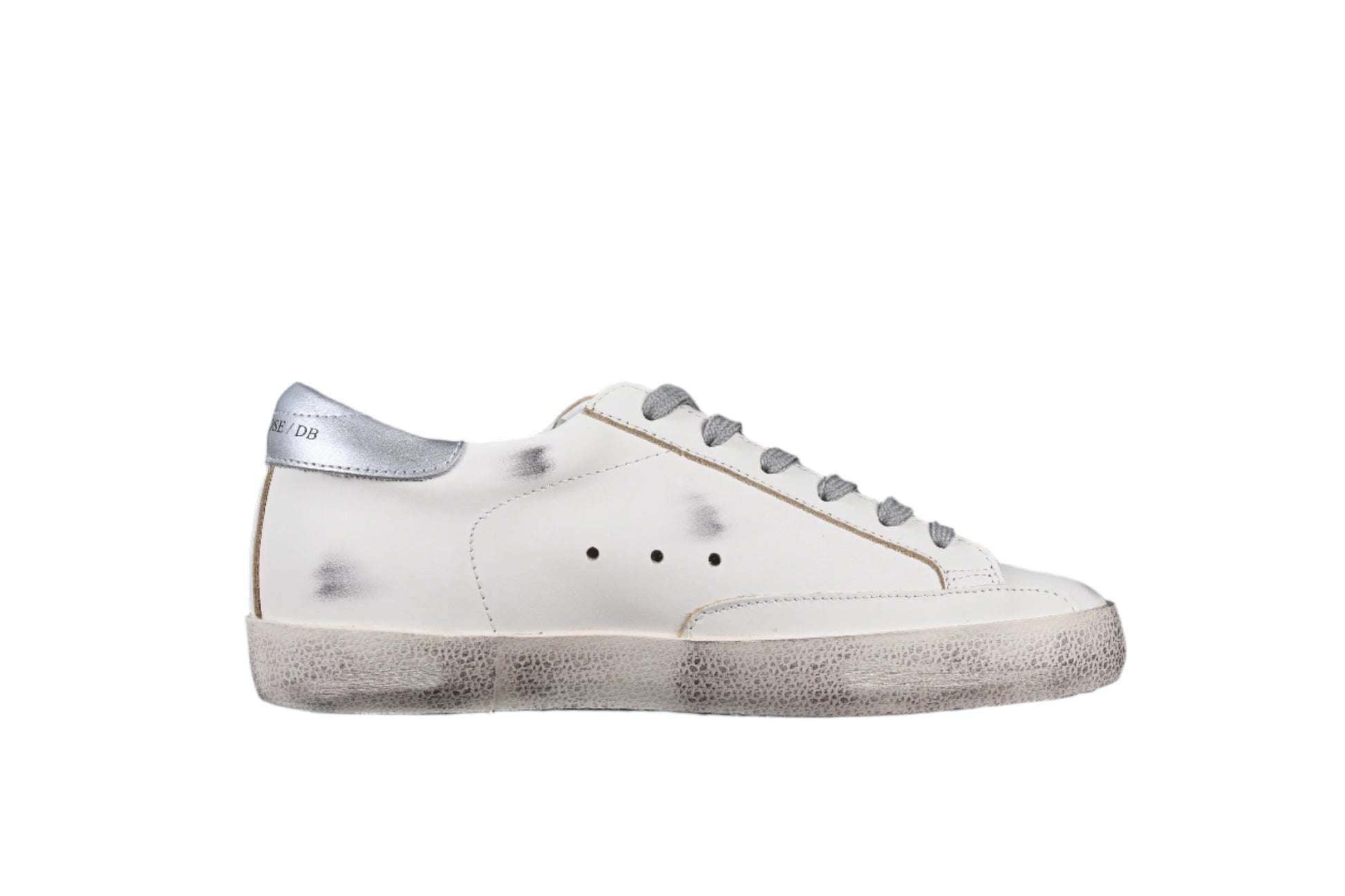 White sneaker with gray laces on a black background