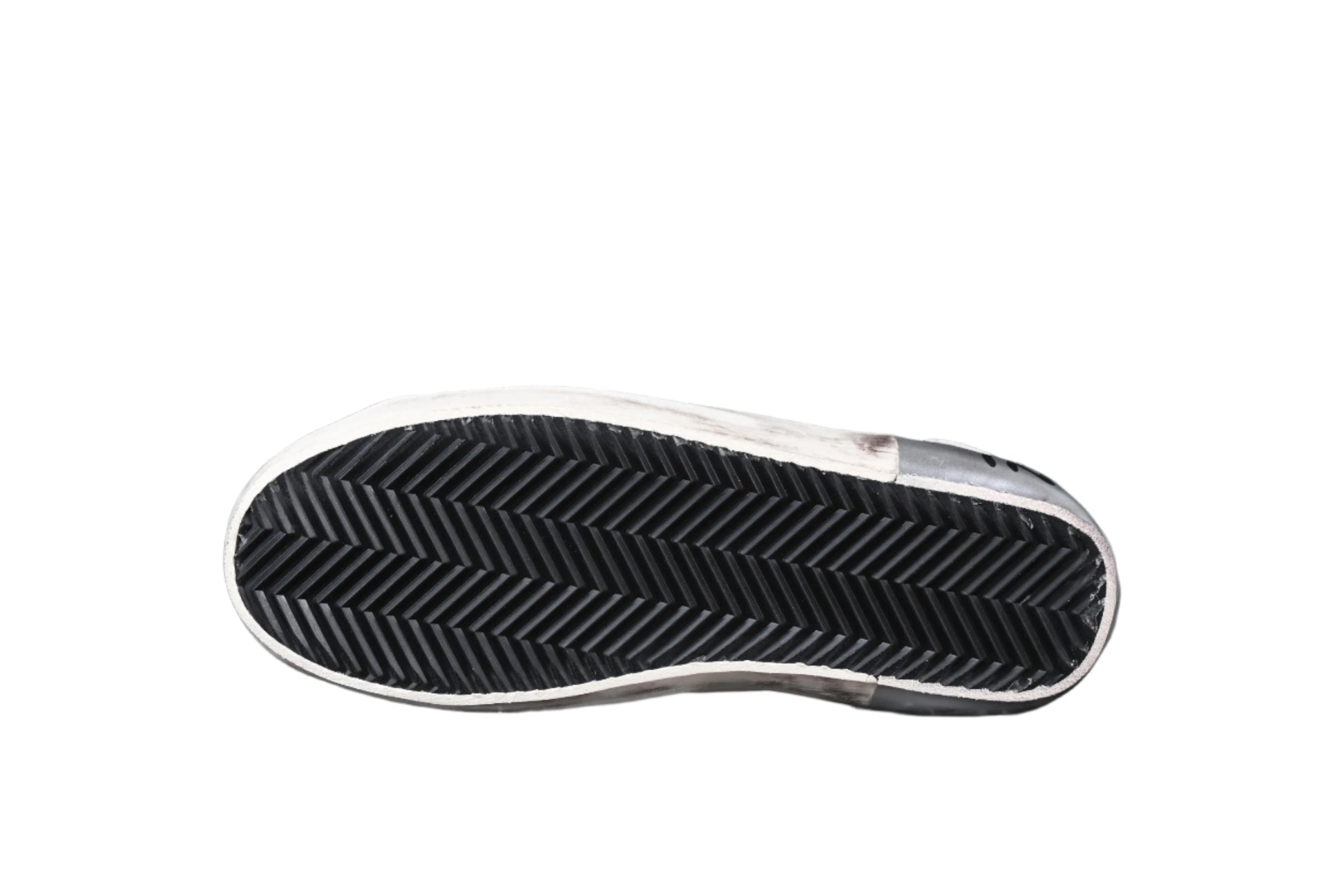 Close-up of a shoe sole with tread pattern on a black background
