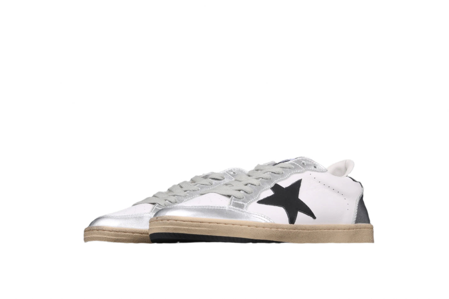 White sneakers with a black star on a black background